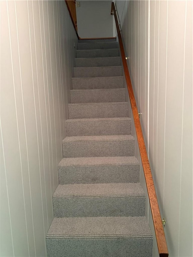 stairway with wood walls