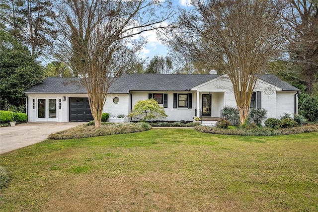 ranch-style home featuring driveway, an attached garage, a front lawn, and brick siding