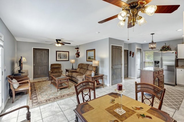 dining room with baseboards, light tile patterned floors, and a ceiling fan