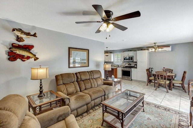 living area with light tile patterned floors, an AC wall unit, and ceiling fan