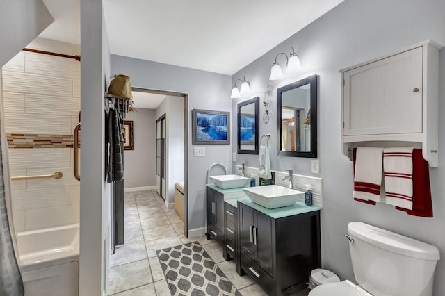 bathroom with tile patterned flooring, toilet, a sink, a tub to relax in, and double vanity