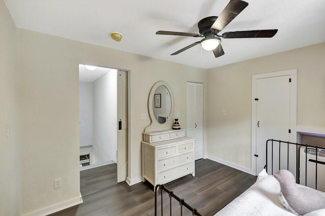 bedroom with dark wood finished floors, baseboards, and ceiling fan