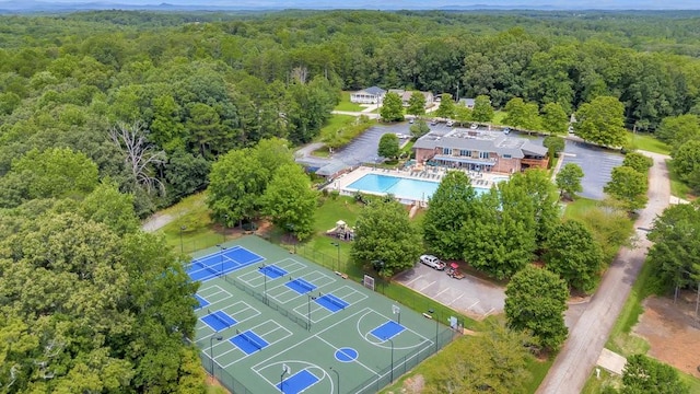 birds eye view of property featuring a wooded view
