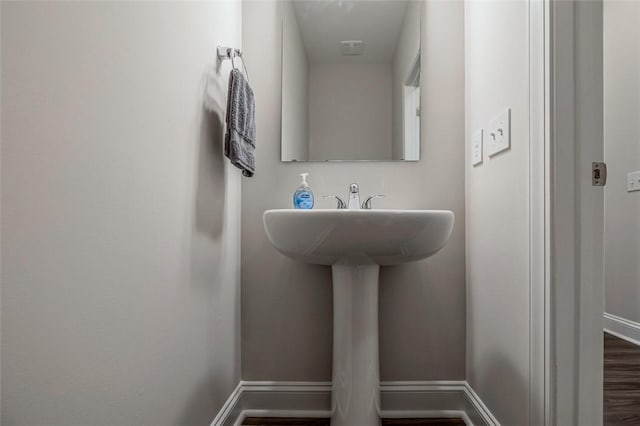 bathroom featuring baseboards and wood finished floors