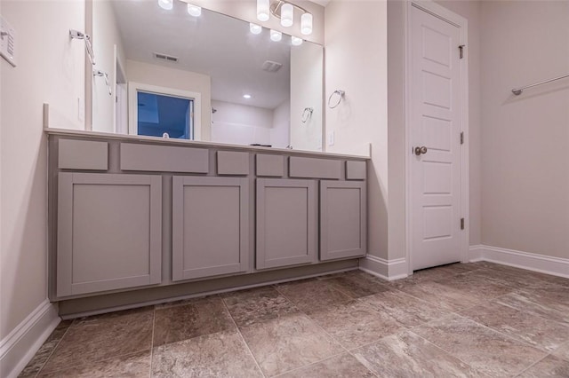 bathroom featuring baseboards and visible vents