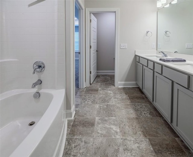 full bathroom featuring baseboards, shower / tub combination, double vanity, and a sink
