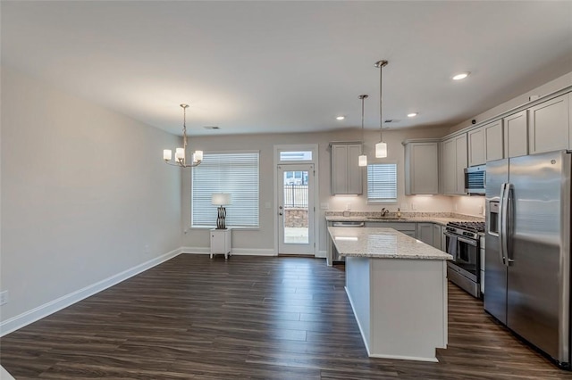 kitchen featuring gray cabinets, a sink, a chandelier, appliances with stainless steel finishes, and dark wood-type flooring