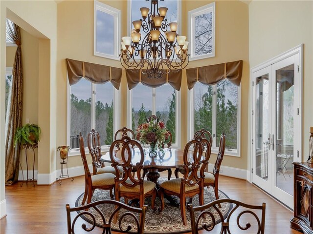 105 Green Cove Way, Six Mile, SC 29682 - dining area featuring french doors, baseboards, a chandelier, a towering ceiling, and wood finished floors
