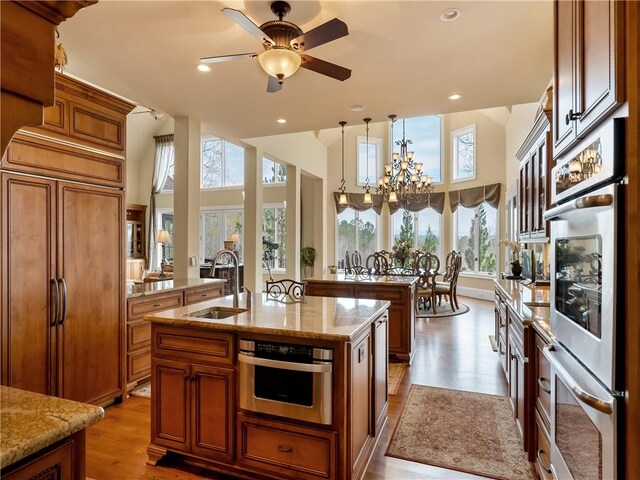105 Green Cove Way, Six Mile, SC 29682 - kitchen with a kitchen island with sink, paneled fridge, a sink, double oven, and brown cabinetry