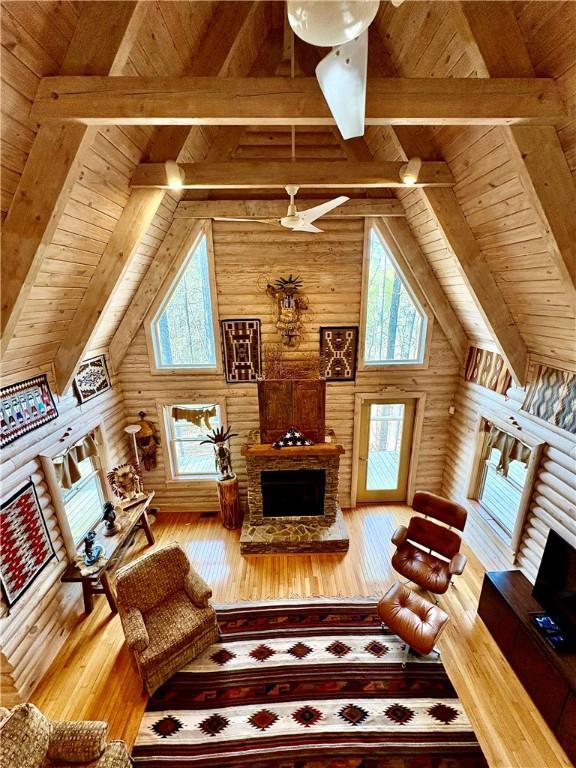 191 Crystal Ln, Townville, SC 29689 - living area featuring a wealth of natural light, beamed ceiling, a fireplace with raised hearth, and hardwood / wood-style floors