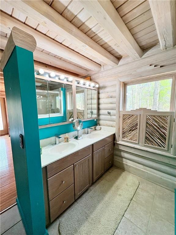 191 Crystal Ln, Townville, SC 29689 - full bathroom featuring beamed ceiling, log walls, double vanity, a sink, and wood ceiling