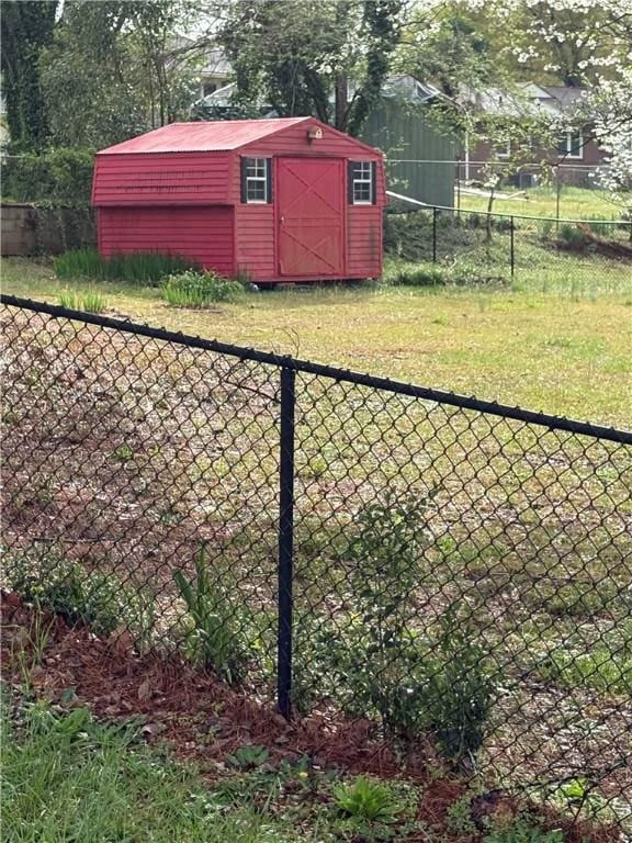 view of yard with a shed, an outdoor structure, and fence