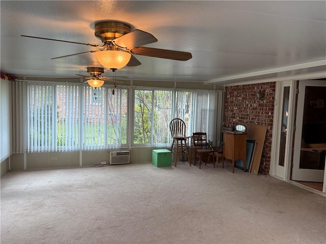 unfurnished sunroom with a wall mounted air conditioner and ceiling fan