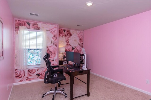 carpeted office space featuring baseboards and visible vents