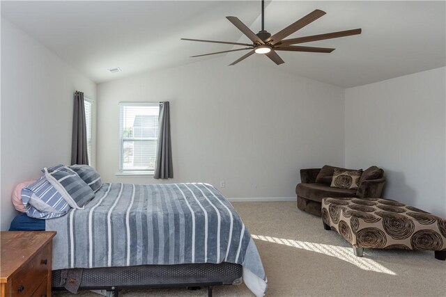bedroom featuring lofted ceiling, a ceiling fan, baseboards, and carpet floors