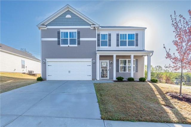 traditional-style home with central air condition unit, an attached garage, driveway, covered porch, and a front yard