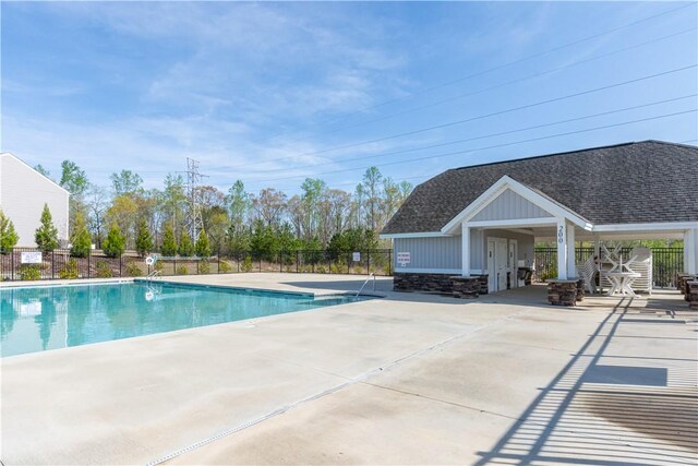 pool featuring a patio area and fence