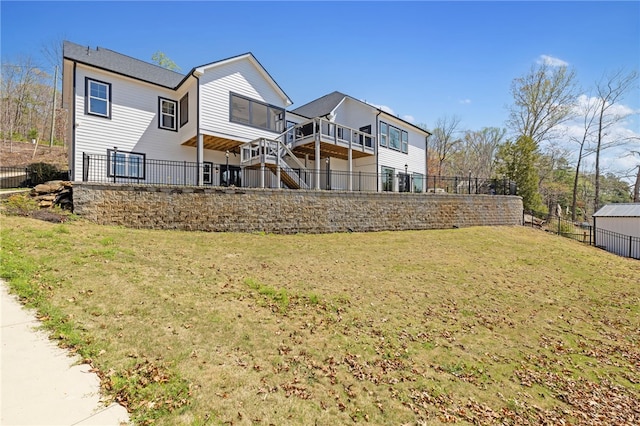 back of property with fence and a lawn
