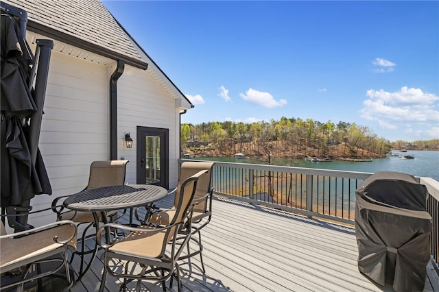 wooden deck with a water view and area for grilling