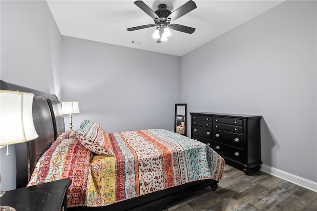 bedroom with baseboards, visible vents, wood finished floors, and a ceiling fan