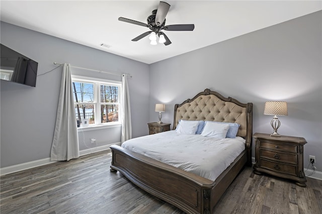 bedroom with baseboards, visible vents, wood finished floors, and a ceiling fan