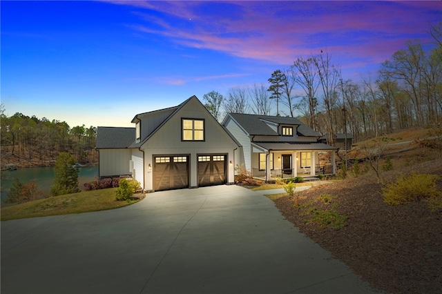 modern farmhouse style home with driveway, covered porch, board and batten siding, and an attached garage