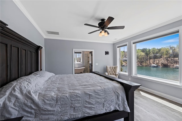 bedroom featuring visible vents, crown molding, baseboards, ceiling fan, and wood finished floors