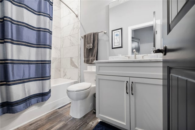 full bathroom with wood finished floors, shower / bath combination with curtain, toilet, and vanity