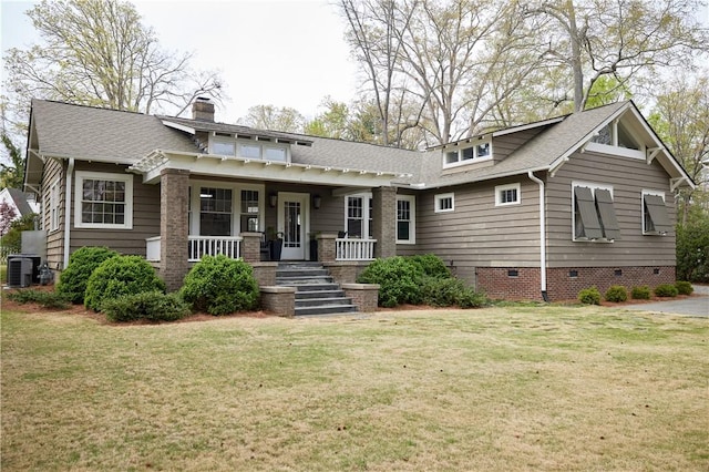 view of front of property with covered porch, central air condition unit, a front lawn, and crawl space