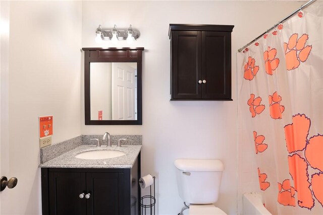 bathroom featuring toilet, shower / bath combination with curtain, and vanity
