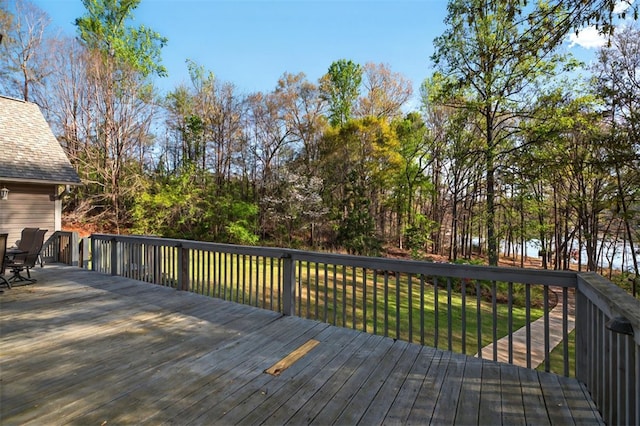 wooden deck featuring a yard