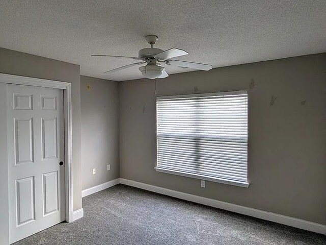 235 Lookover Dr, Anderson, SC 29621 - empty room featuring ceiling fan, carpet floors, and a textured ceiling