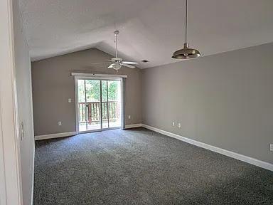 235 Lookover Dr, Anderson, SC 29621 - unfurnished room with dark colored carpet, vaulted ceiling, and a ceiling fan