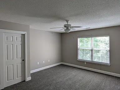235 Lookover Dr, Anderson, SC 29621 - spare room featuring ceiling fan, dark colored carpet, and a textured ceiling
