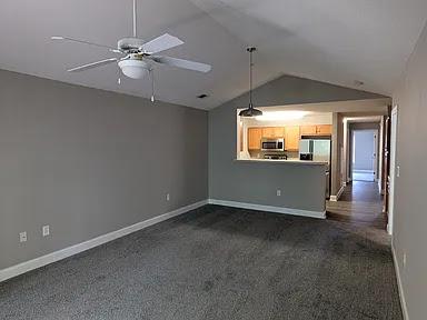 235 Lookover Dr, Anderson, SC 29621 - unfurnished living room with dark colored carpet, lofted ceiling, and ceiling fan