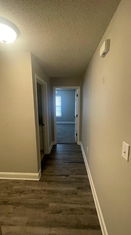 235 Lookover Dr, Anderson, SC 29621 - hallway featuring a textured ceiling and dark wood-style flooring