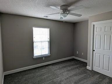 235 Lookover Dr, Anderson, SC 29621 - unfurnished bedroom featuring dark colored carpet, a textured ceiling, and ceiling fan