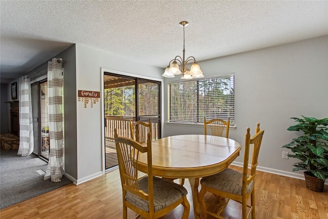 203 W Blue Heron Dr, Salem, SC 29676 - dining area with an inviting chandelier, baseboards, light wood-style floors, and a textured ceiling