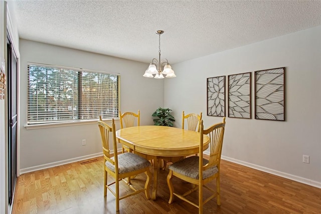 203 W Blue Heron Dr, Salem, SC 29676 - dining space with an inviting chandelier, light wood-style flooring, baseboards, and a textured ceiling