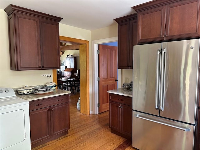 171 E Main St, Pendleton, SC 29670 - kitchen featuring freestanding refrigerator, light stone countertops, washer / dryer, and light wood-type flooring