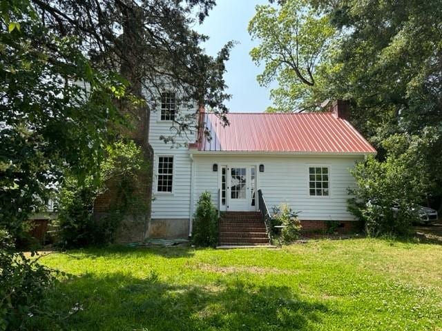 171 E Main St, Pendleton, SC 29670 - rear view of house featuring a lawn, metal roof, entry steps, and a chimney