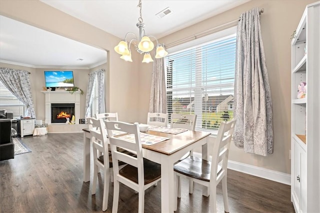 185 Norfolk Cir, Anderson, SC 29625 - dining room featuring a lit fireplace, dark wood-style floors, visible vents, and a notable chandelier