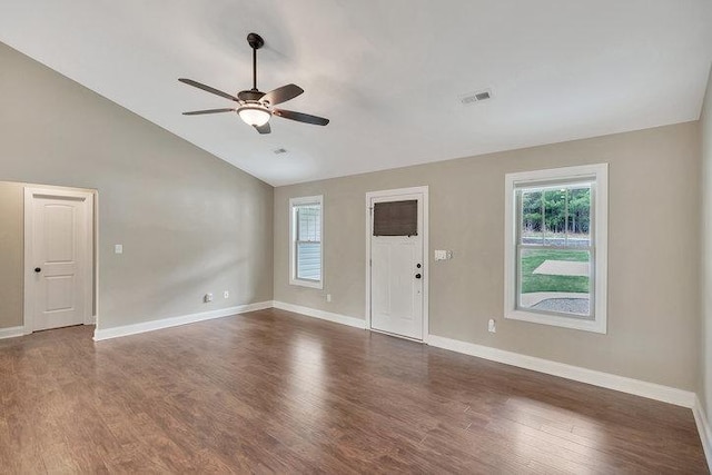 interior space with dark wood-style flooring, visible vents, baseboards, a ceiling fan, and lofted ceiling