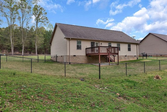 back of property with a fenced backyard, crawl space, a wooden deck, and a yard