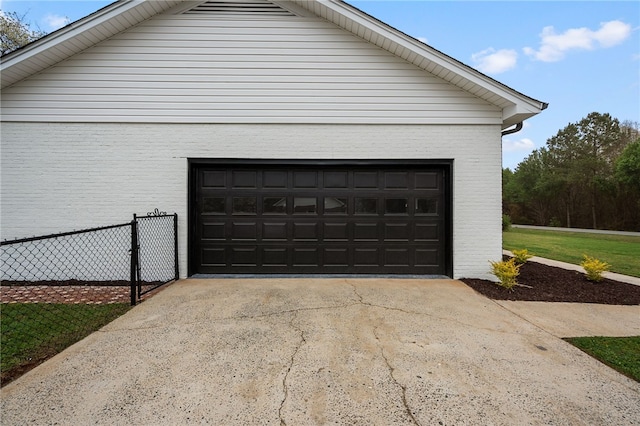 detached garage featuring fence