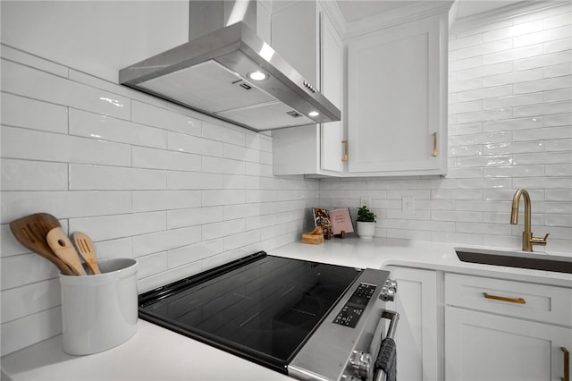 kitchen featuring a sink, white cabinetry, wall chimney range hood, and stainless steel electric range