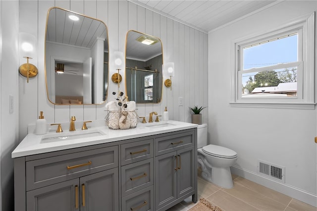 bathroom with double vanity, a sink, a shower stall, and visible vents