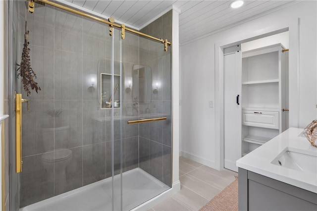 bathroom with a stall shower, tile patterned floors, and vanity