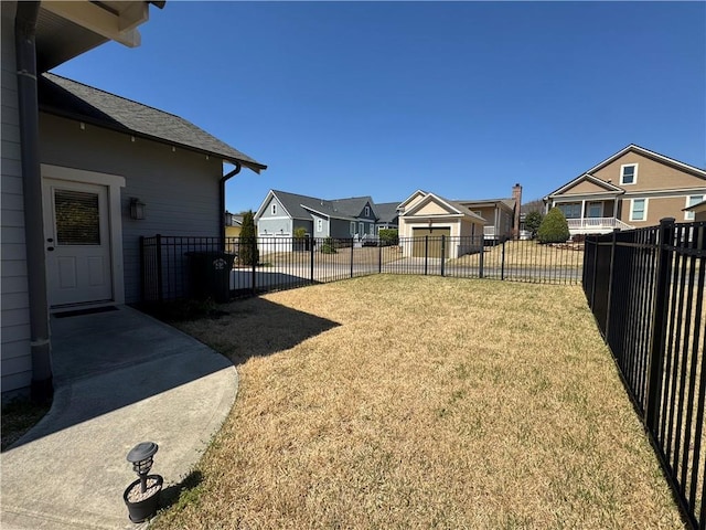 view of yard featuring fence and a residential view