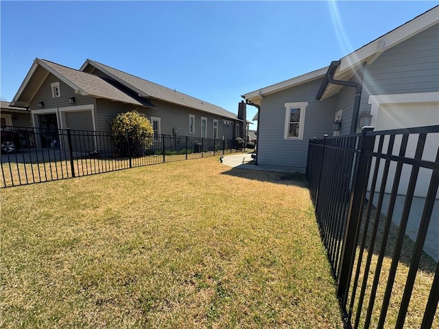 view of yard featuring a fenced backyard and an attached garage